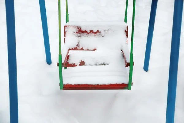 Swing covered with snow — Stock Photo, Image