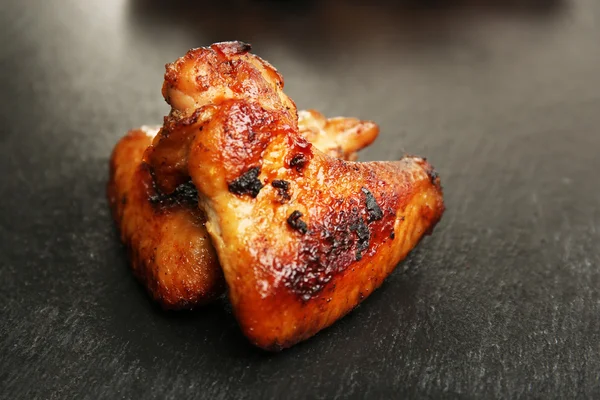 Baked chicken wings on slate plate — Stock Photo, Image