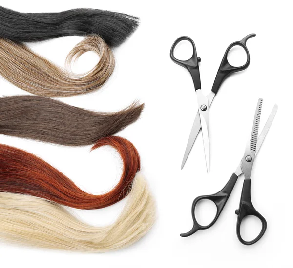 Hairdresser's scissors with varicolored strands of hair — Stock Photo, Image