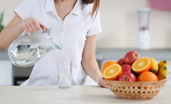 Woman pouring water — Stock Photo, Image