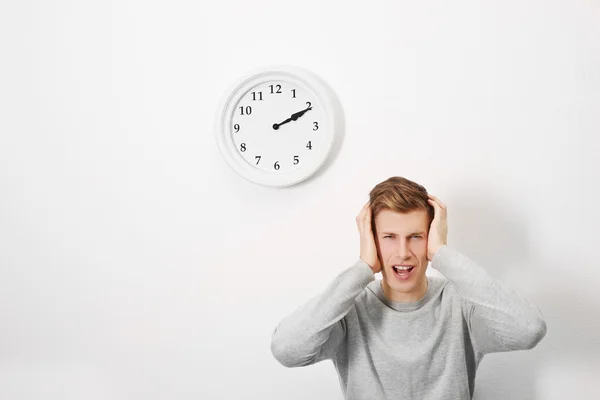 Man and clock on wall — Stock Photo, Image