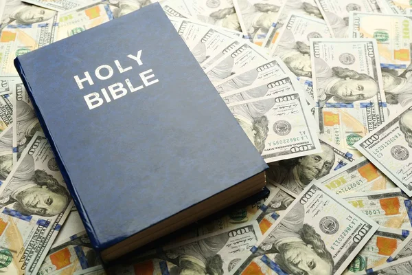 Holy Bible on money — Stock Photo, Image