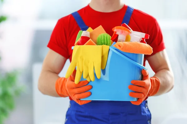 Janitor holding cleaning products — Stock Photo, Image