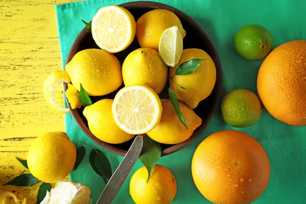 Fresh citrus fruits on a yellow wooden table. — Stock Photo, Image