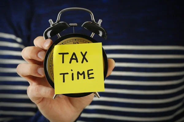 Man holding alarm clock — Stock Photo, Image