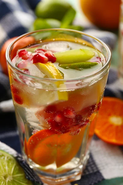 Refreshing cocktail with ice, mint,  pomegranate seeds and slices of fruits — Stock Photo, Image