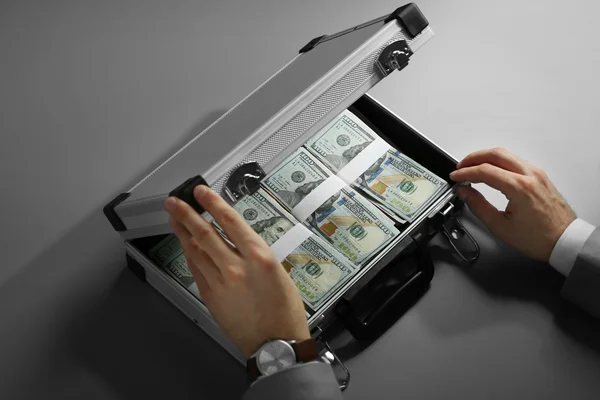 Businessman with case full of money — Stock Photo, Image