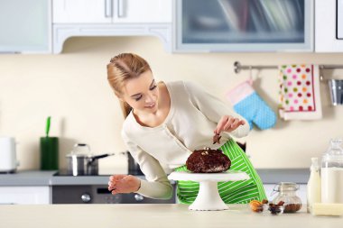 Young woman decorating cake with chocolate clipart