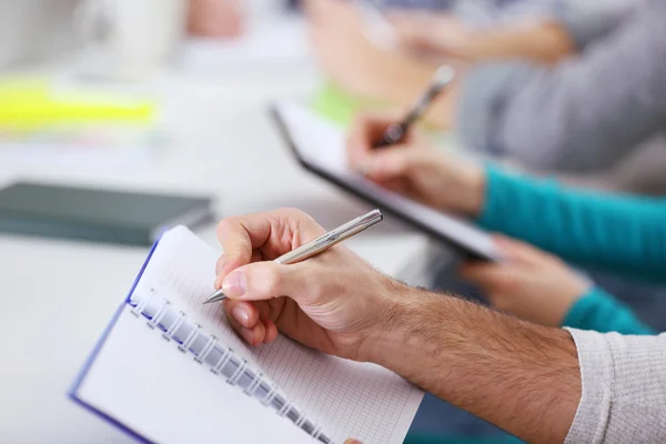 Young man making notes — Stock Photo, Image