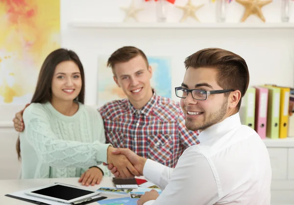 Agent en jonge paar handshaking — Stockfoto