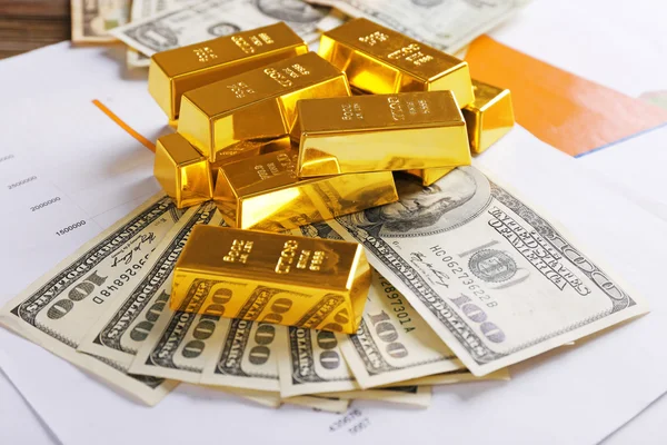 Gold bars with dollar banknotes — Stock Photo, Image