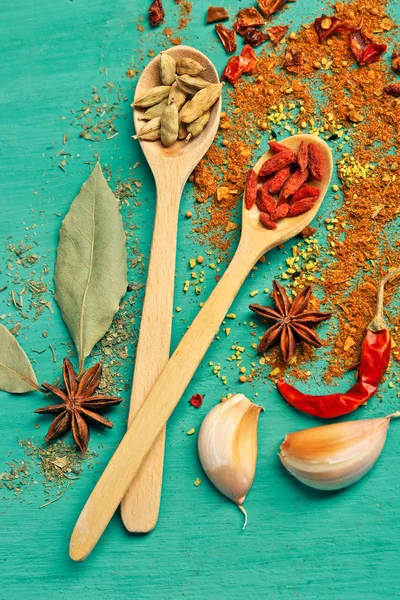 Assorted spices on wooden background — Stock Photo, Image