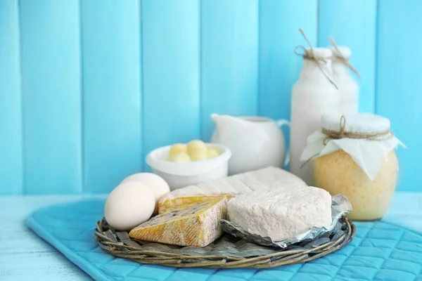 Set of fresh dairy products on blue wooden table, close up — Stock Photo, Image