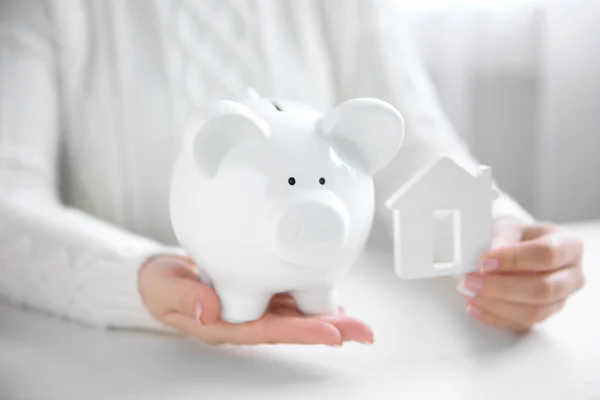 Woman holding white piggy bank — Stock Photo, Image