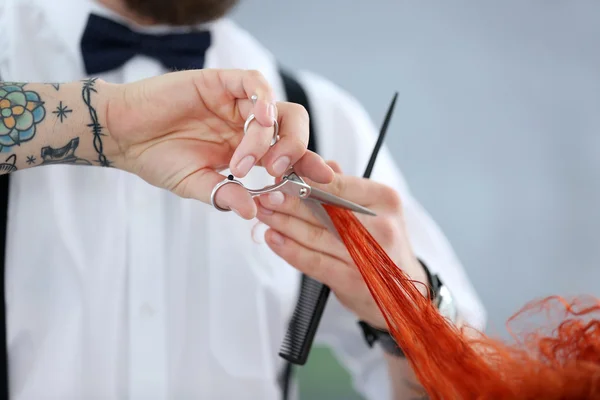 Hairdresser cutting red curls — Stock Photo, Image