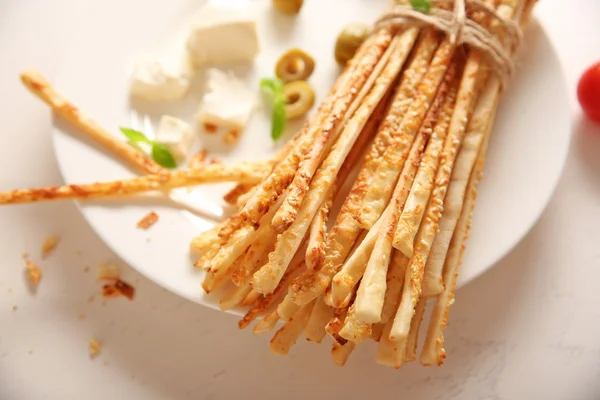 Bread sticks grissini with sesame seeds on a white plate — Stock Photo, Image