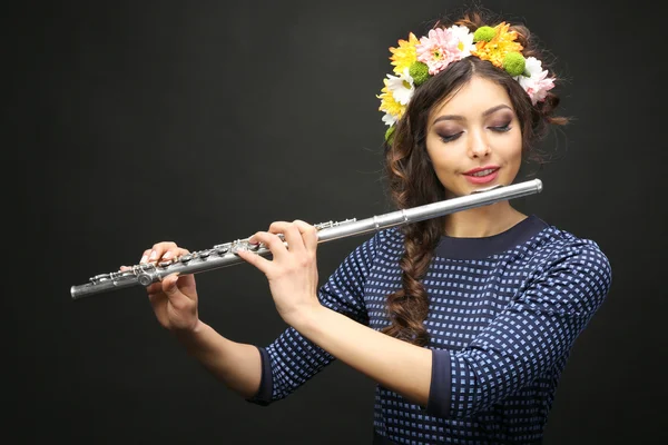 Beautiful young woman with flute on black background — Stock Photo, Image