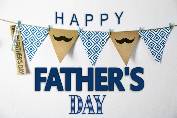 Happy Father's Day. Triangle garland with mustache and pattern hanging on wall — Stock Photo, Image