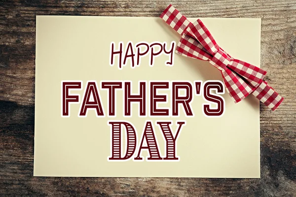 Happy Father's Day. Red cell bow tie on wooden background — Stock Photo, Image