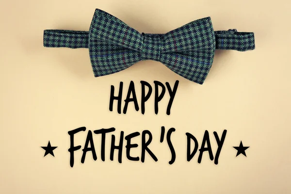 Happy Father's Day. Male bow tie on beige background — Stock Photo, Image