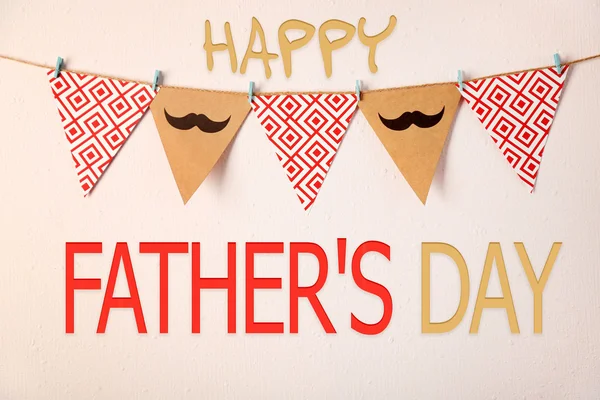 Happy Father's Day. Triangle garland with mustache and pattern hanging on wall — Stock Photo, Image
