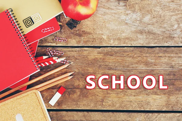 School supplies on old wooden table — Stock Photo, Image