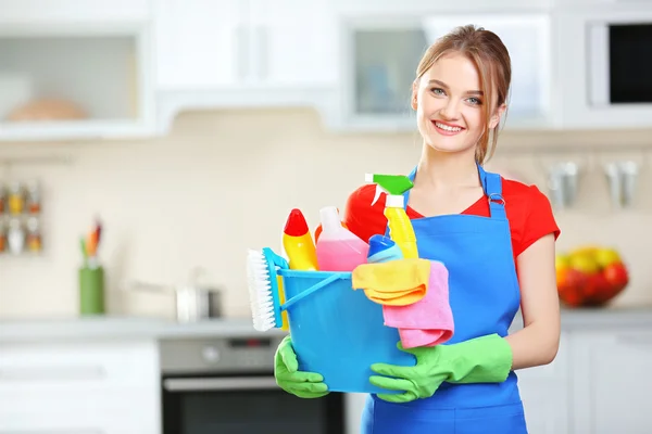 Woman holds basin with washing fluids — Stock Photo, Image