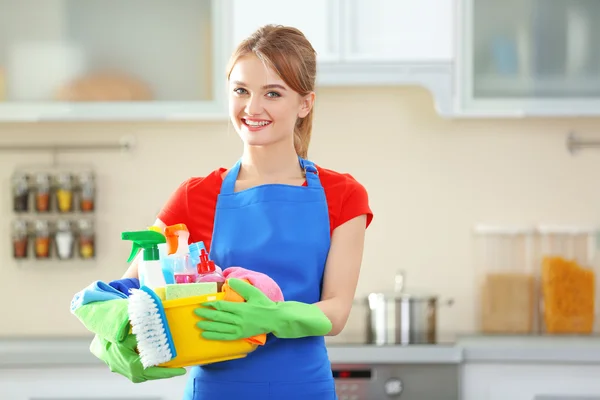 Woman holds basin with washing fluids — Stock Photo, Image