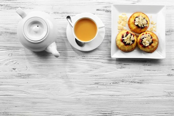 Coffee with cakes on wooden background