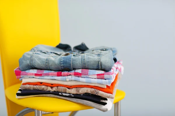 Clean male clothes on yellow chair — Stock Photo, Image