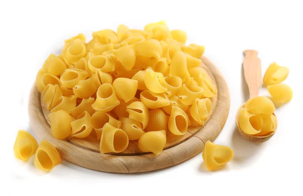 Pile of Italian dry pasta on a wooden board,  isolated on white — Stock Photo, Image