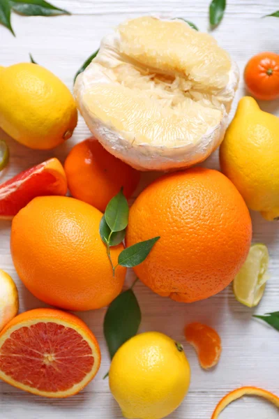 Various citrus fruits on wooden table — Stock Photo, Image