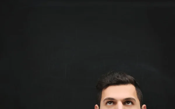 Forehead of a young man  against blackboard. — Stock Photo, Image