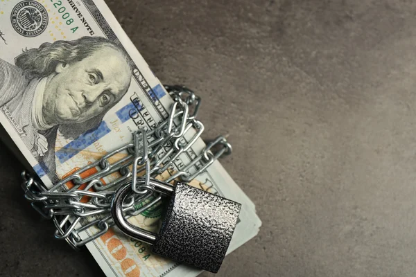 Dollars currency with lock and chain — Stock Photo, Image