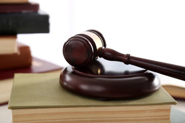 Gavel with books on wooden table — Stock Photo, Image