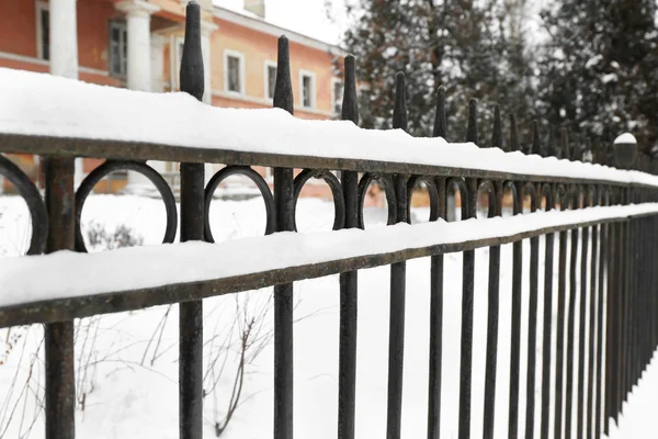 Iron fence in winter yard — Stock Photo, Image