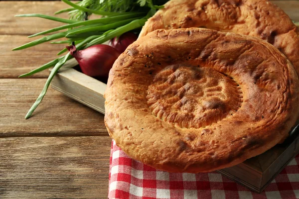 Fresh fried bread with onion on wooden table closeup — Stock Photo, Image