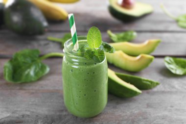 Ahşap arka plan dilimleri ile taze avokado güler yüzlü