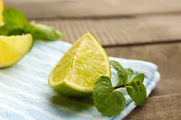 Slice of fresh lime on blue napkin closeup — Stock Photo, Image