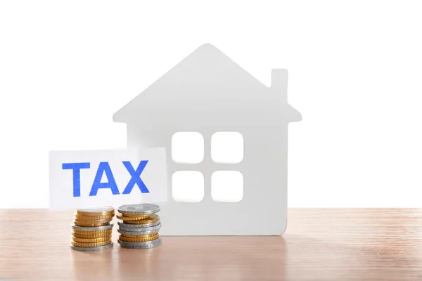 House figure, coins and tax sign — Stock Photo, Image