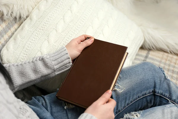 Young woman holding a brown book — Stock Photo, Image