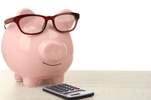 Banco Piggy com óculos e calculadora — Fotografia de Stock