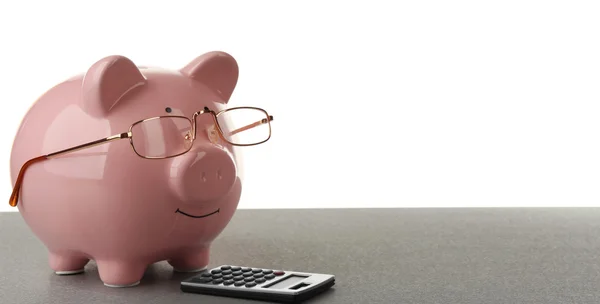 Banco Piggy com óculos e calculadora — Fotografia de Stock