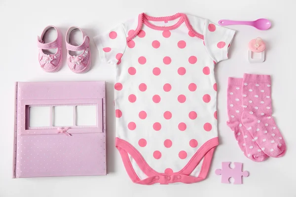 Baby clothes with photo album — Stock Photo, Image