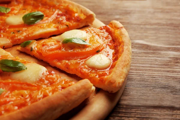 Gesneden pizza Margherita op houten achtergrond, close-up — Stockfoto