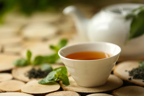 Cup of tea and teapot on table — Stock Photo, Image