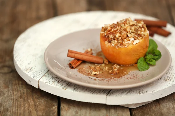 Baked apple with honey, raisins and walnut on white plate — Stock Photo, Image