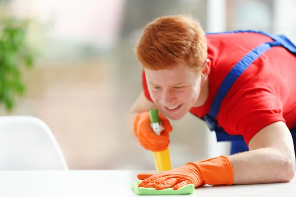 Young janitor with liquid detergent — Stock Photo, Image