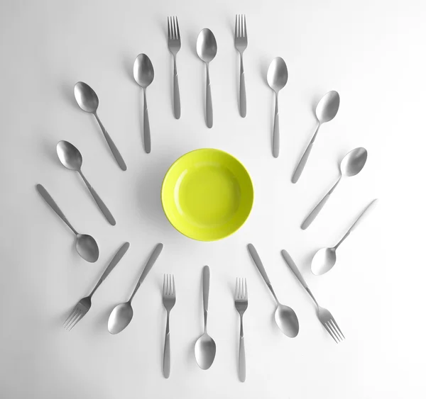 Plate, silver spoons and forks — Stock Photo, Image