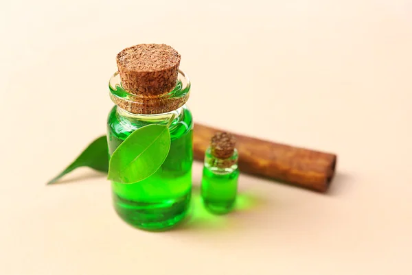 Bottles of tea oil and cinnamon — Stock Photo, Image